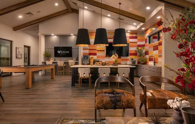the lobby of a clubhouse with tables and chairs and a pool tableat Weylyn Luxury Apartments, Laveen, AZ