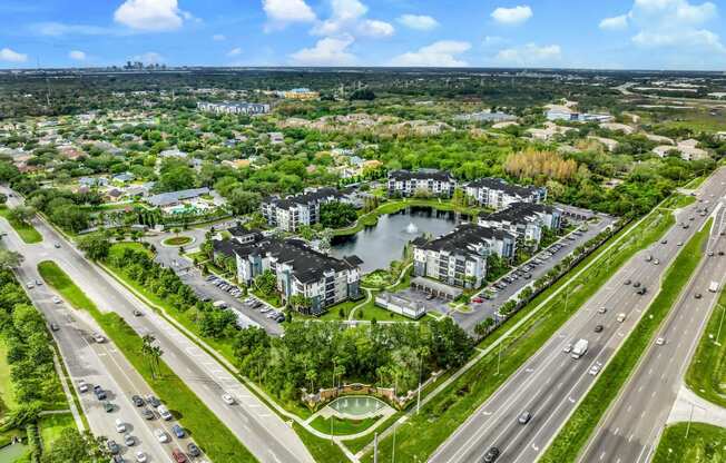 Aerial view of a city with a pond and cars on the road at Pearce at Pavilion Luxury Apartments, Riverview
