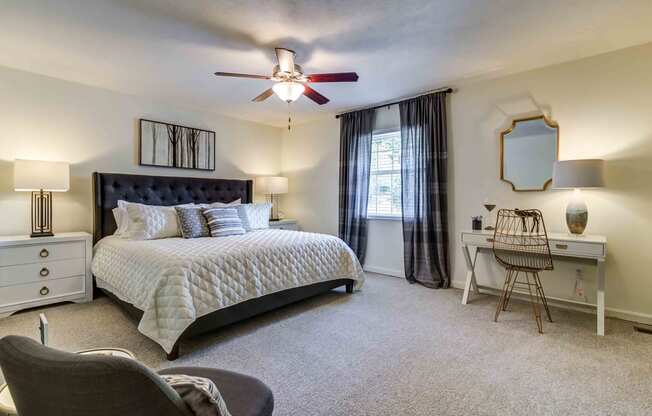 staged bedroom with carpeted flooring, lighted ceiling fan, and window