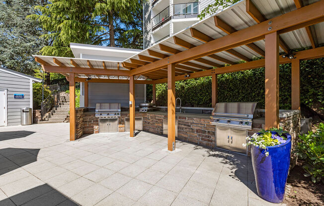 a patio with a barbecue grill and a pergola