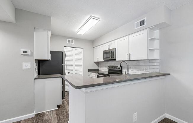 a white refrigerator freezer sitting inside of a kitchen