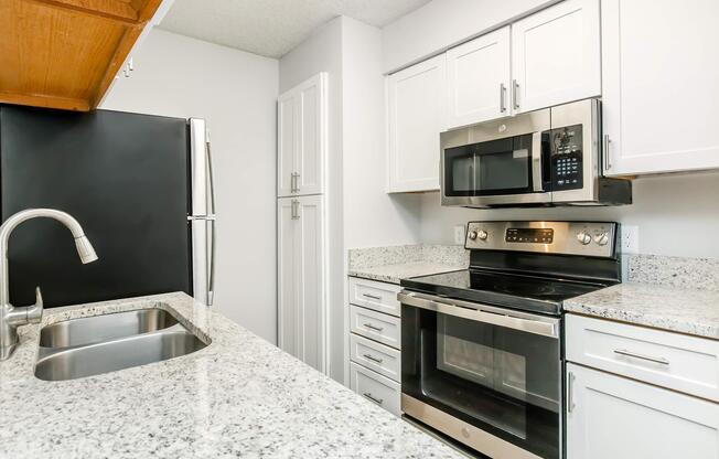 a kitchen with a sink and a microwave