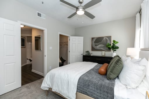 a bedroom with a large bed and a ceiling fan