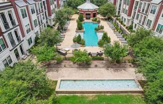 an aerial view of the pool and courtyard of an apartment building