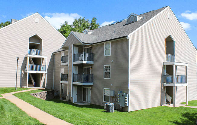 Apartment complex with a walkway in front.