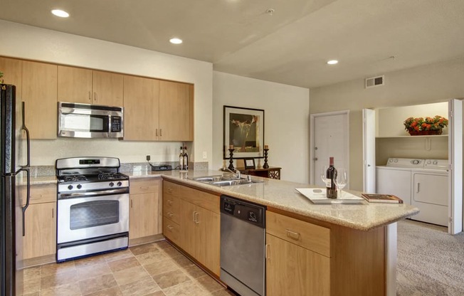 a kitchen with wooden cabinets and stainless steel appliances