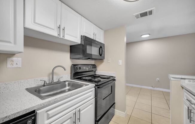 the kitchen of our studio apartment atrium with stainless steel appliances and white cabinets