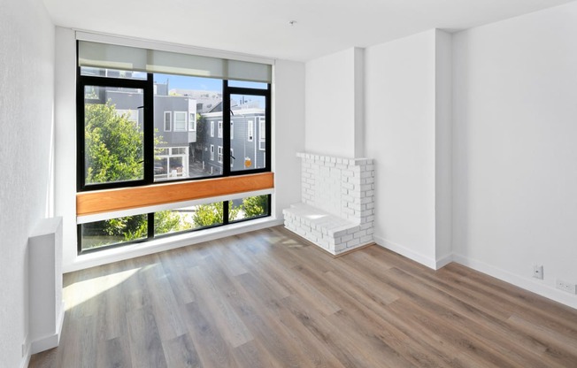an empty living room with a large window