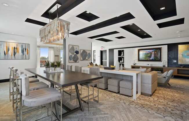 a dining room and living room with a long table and chairs