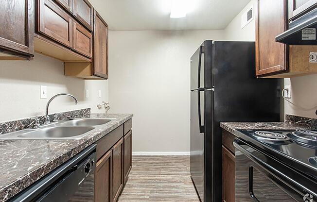 a kitchen with stainless steel appliances and wooden cabinets