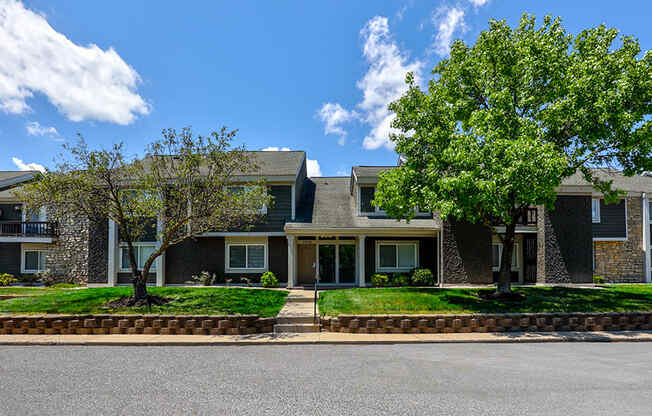 Exterior of a building at Somerset Lakes Apartments, showcasing a well-maintained facade and beautiful landscaping.