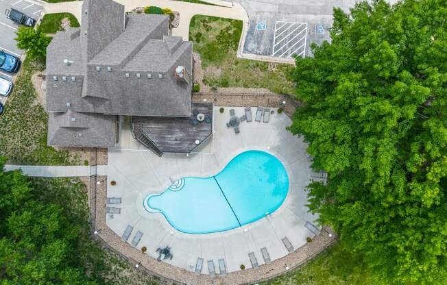 an aerial view of a house with a swimming pool