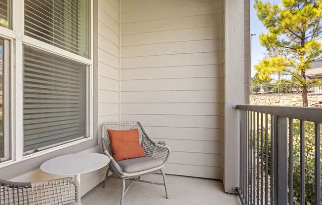 A patio with a chair and a table.