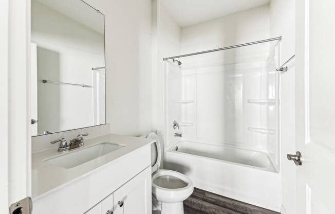 Spacious bathroom in Dogwood home with a bathtub and tile flooring at Beacon at Presidential Heights in Manor, TX