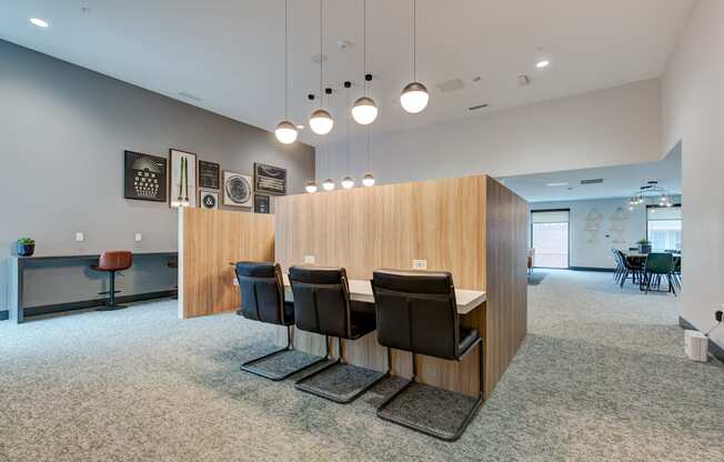 a dining room with a table and chairs in front of a wood wall