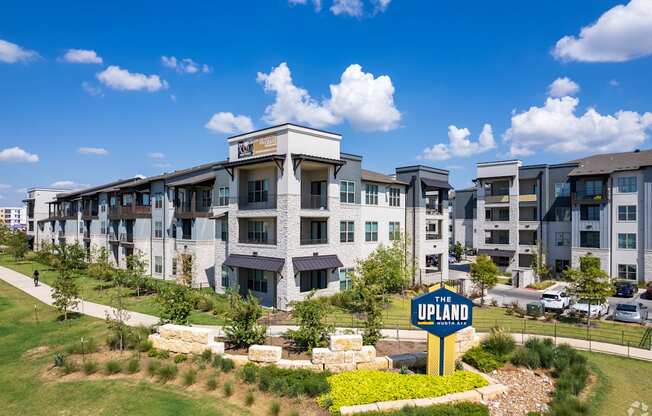 a large apartment building with a sign in front of it