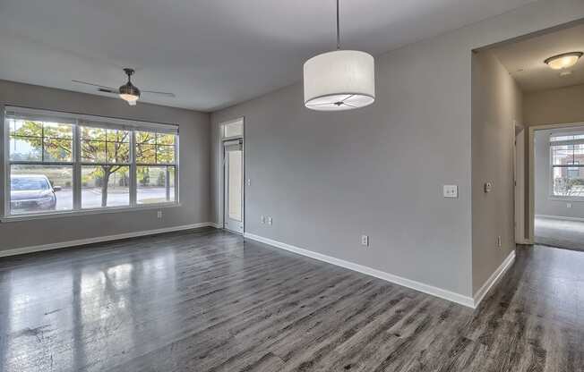 an empty living room with a large window at Nexus at Sandhill, Columbia, SC