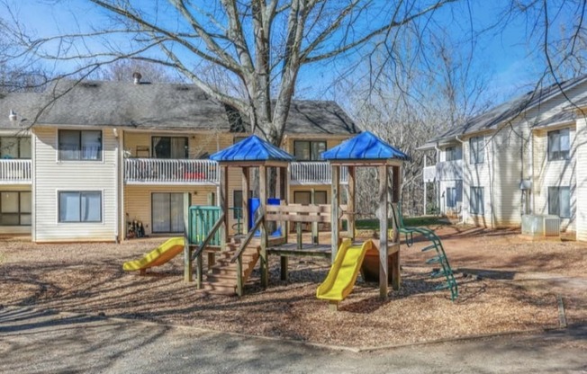 a playground in a yard in front of a house