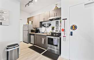 a kitchen with stainless steel appliances and white walls