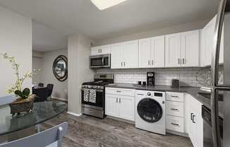 PLATINUM Kitchen with built in washer/dryer combo at Trillium Apartments, Fairfax