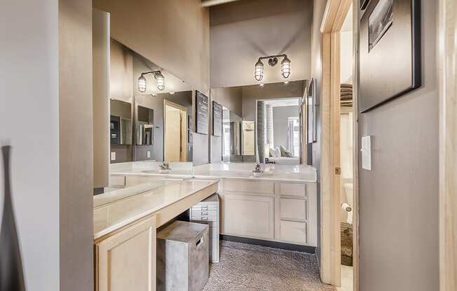 bathroom with light countertops and multiple mirrors