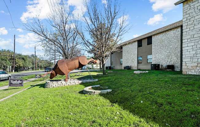 a sculpture of a horse in front of a building