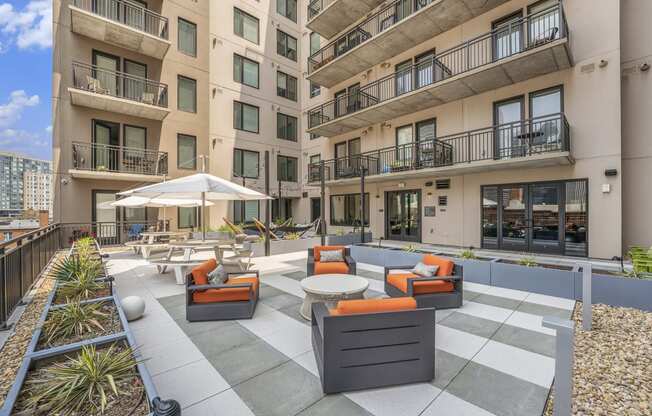 an outdoor lounge area at the bradley braddock road station apartments