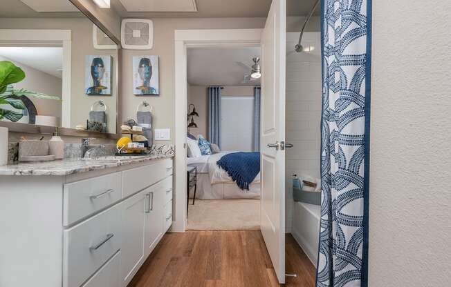 bathroom that's connected to a bedroom at escape at arrowhead's apartments in glendale, az
