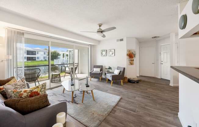 a living room with a sliding glass door to a balcony