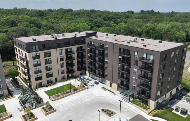 an aerial view of an apartment complex with trees in the background