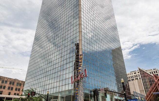 a tall building with a reflection of the sky in it at 310 at Nulu Apartments-Student, Louisville