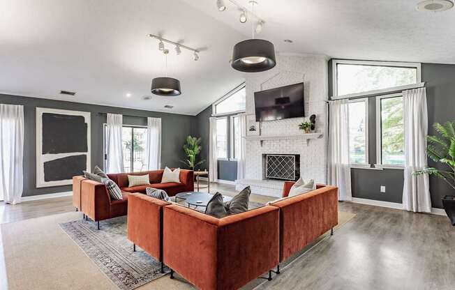 A modern living room with a red couch and a fireplace