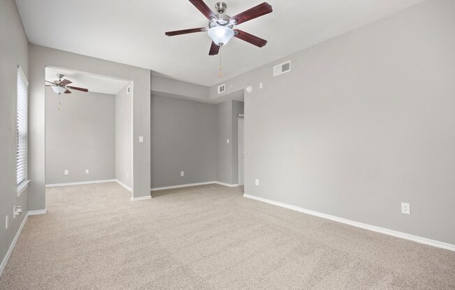 a large empty room with a ceiling fan at Waters Edge Apartment Homes, Georgetown, TX