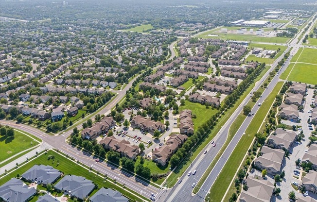 A suburban neighborhood with rows of houses and a road running through it.