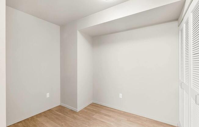 A room with white walls and wooden flooring.