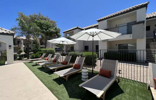 Lounge in luxury by our pool deck with plenty of comfy chairs for ultimate relaxation at Boulders at Lookout Mountain Apartment Homes, Phoenix, AZ 85022