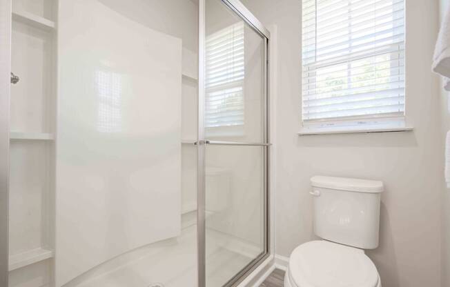 a bathroom with a toilet and a glass shower