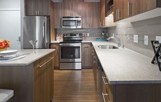 a kitchen with wooden cabinets and stainless steel appliances