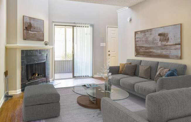 Greentree Apartments in Savannah, GA photo of a living room with a couch and a table and a fireplace