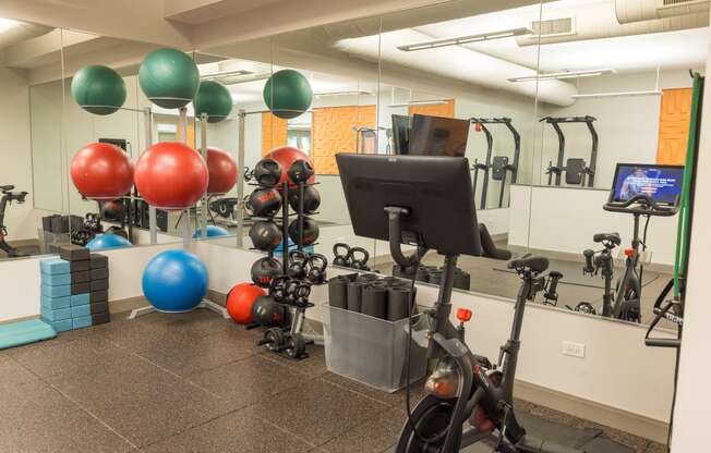 a workout room with exercise equipment and balloons