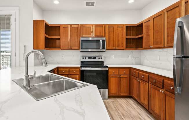 a large kitchen with wooden cabinets and stainless steel appliances