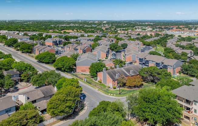 an aerial view of a neighborhood with houses and trees