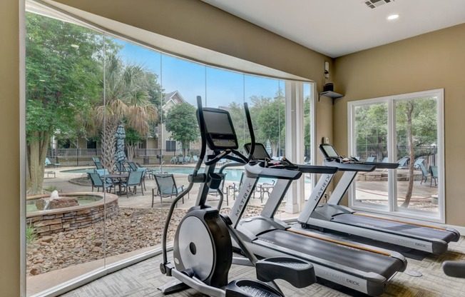 the residence on lamar apartment homes fitness center with gym equipment and large windows