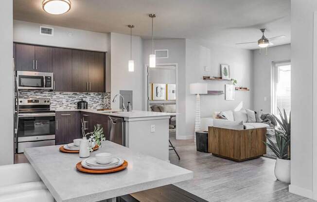 omfortable dining area overlooking spacious living room with natural light