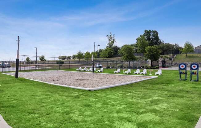 A grassy field with a target range and a fence.