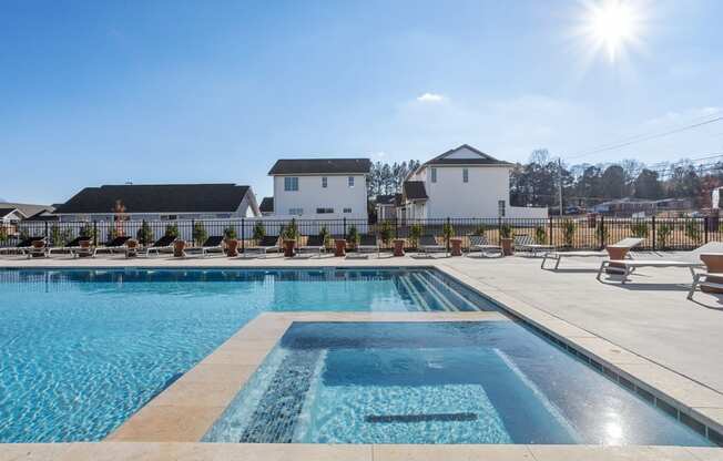 the large swimming pool, spa, and sundeck surrounded by homes at Sanctuary at Indian Creek Rental Homes in Huntsville