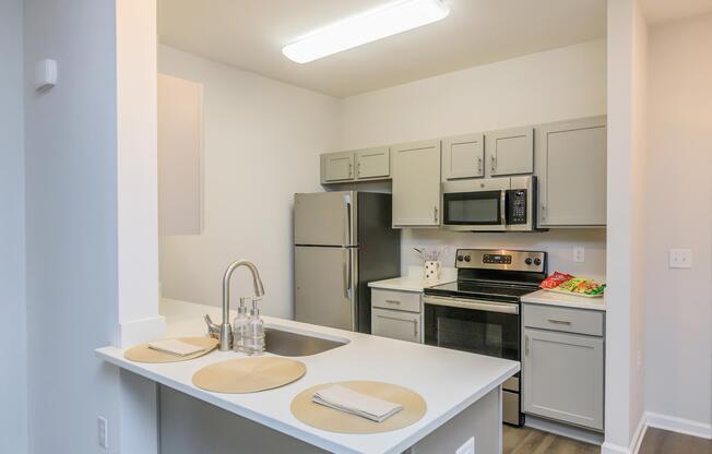 a kitchen with a stove a sink and a microwave