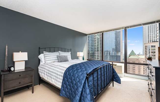 a bedroom with a large bed and a large window