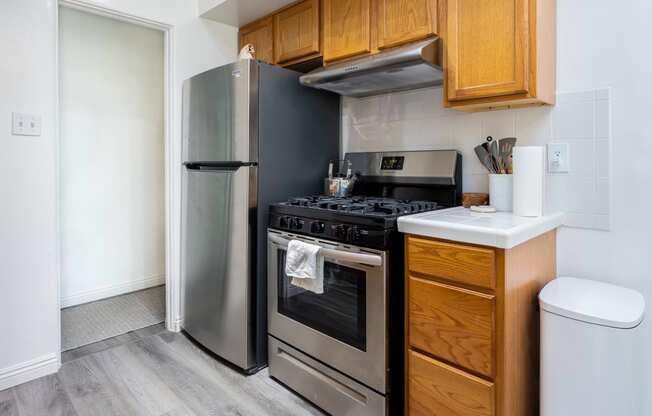 a kitchen with wooden cabinets and stainless steel appliances