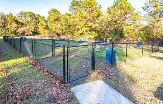 the dog park is fenced in with a chain link fence